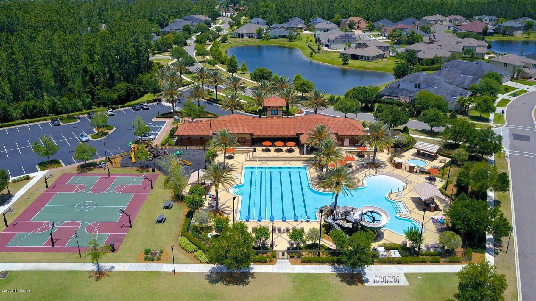Aerial view of the amenity center, pool and lake in a St Johns County community